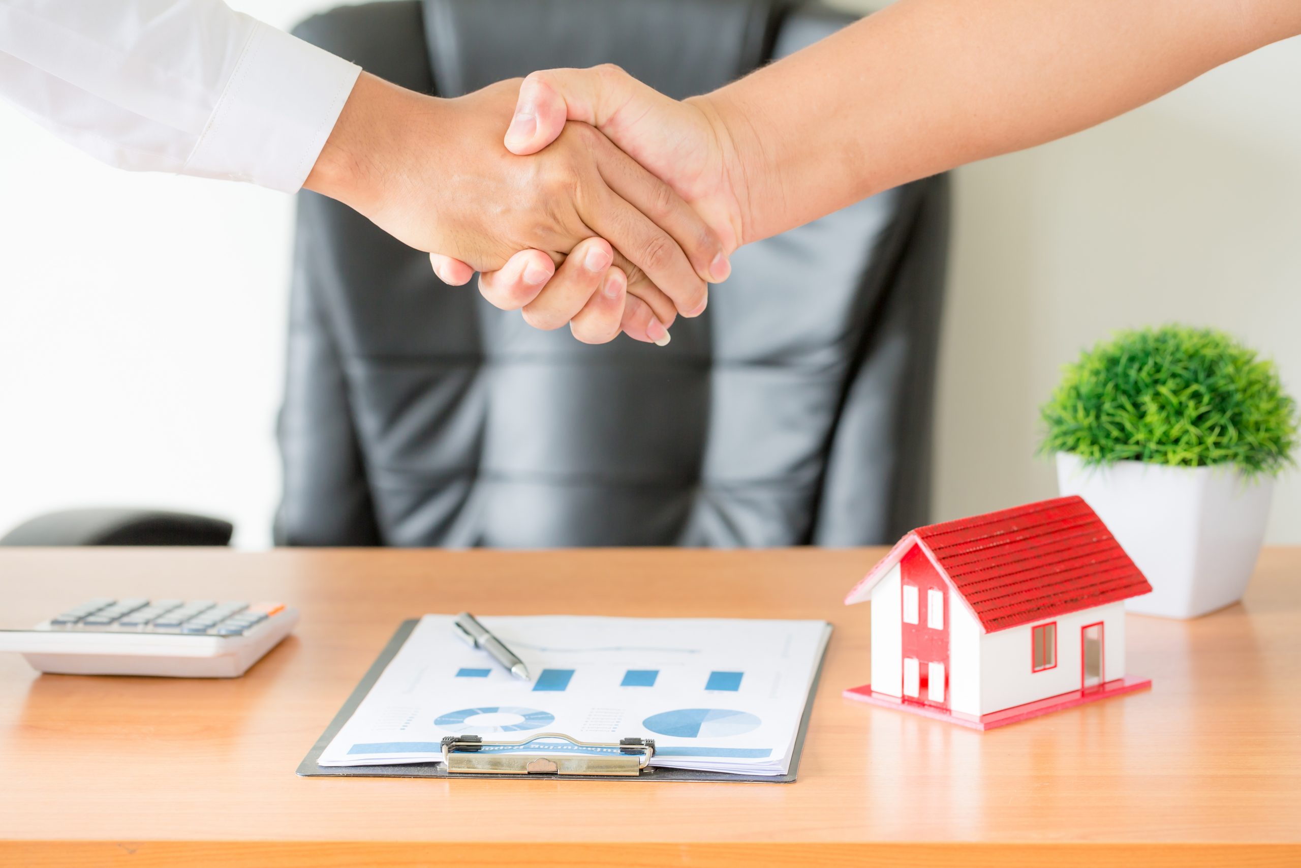 hands of agent and client shaking hands after signed contract bu Business loan